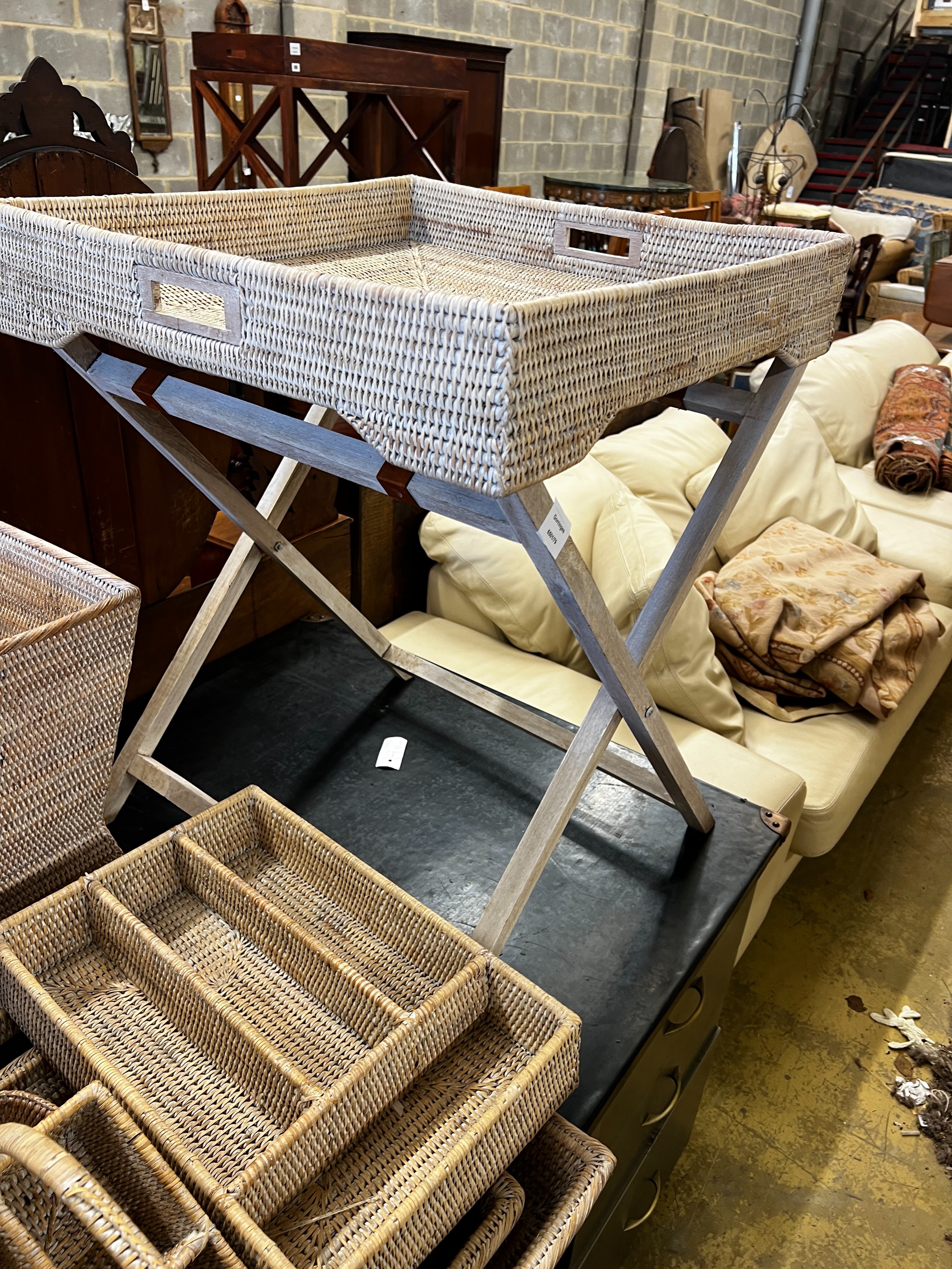 A wicker tray on folding stand together with nine other pieces of wickerwork